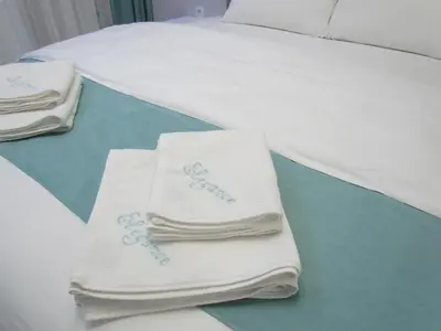 two towels are sitting on top of a bed at Апартаменти Елеганс in Sandanski