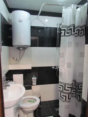 a small bathroom with a toilet and a sink at Апартаменти Елеганс in Sandanski