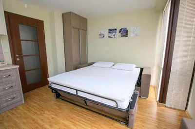 a bedroom with a bed with two pillows on it at Feel at Home in Sandanski