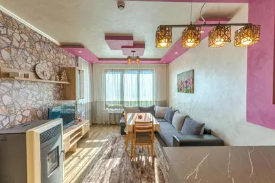 a living room with a couch and a table at Sweet Home апартамент 530 Смолянски езера in Smolyan