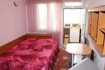 a small bedroom with a bed with a pink blanket at Orchideia Studios in Sandanski