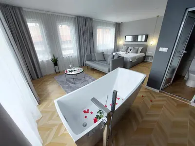 a living room with a bath tub in the middle of a room at Студио с вана и гледка в 