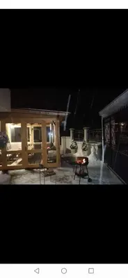 a fire pit in a backyard at night at Къща Томови,стаи за гости in Devin