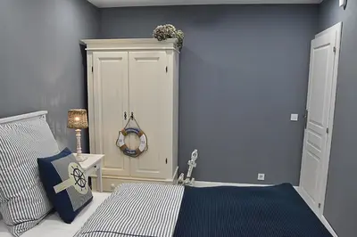 a bedroom with a bed and a white cabinet at GUESTHOUSE MARIA / КЪЩА ЗА ГОСТИ МАРИЯ / GÄSTEHAUS MARIA in Karlovo