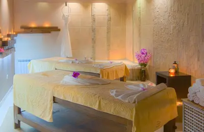a room with two beds with towels on them at Royal Spa Hotel in Velingrad