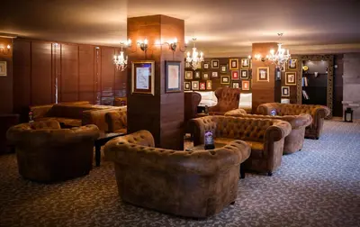 a lobby with couches and chairs in a room at Royal Spa Hotel in Velingrad