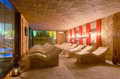 a row of benches in a room with a window at Royal Spa Hotel in Velingrad