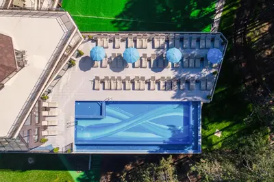an aerial view of a building with blue at Villa Dea & Villa Ina - Villas & SPA Park in Velingrad by Flat Mаnager in Velingrad