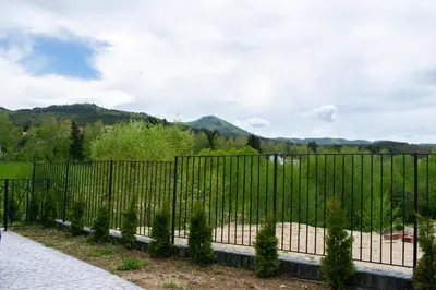 a fence with a view of a mountain at Villa Dea & Villa Ina - Villas & SPA Park in Velingrad by Flat Mаnager in Velingrad