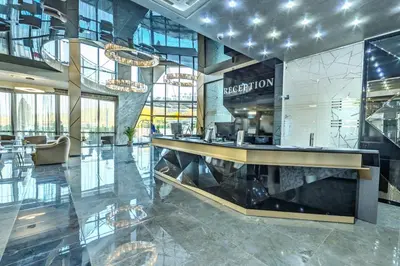 a lobby with a reception desk in a building at Villa Dea & Villa Ina - Villas & SPA Park in Velingrad by Flat Mаnager in Velingrad