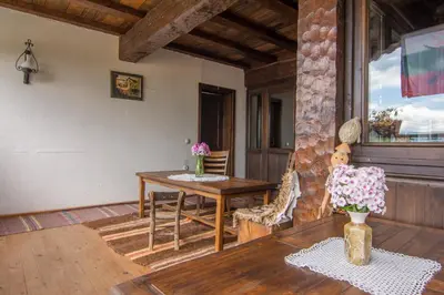 a dining room with a table and a window at Къща Стара Македония in Gostun