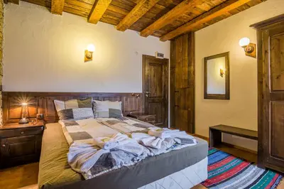 a bedroom with a large bed in a room at Къща Стара Македония in Gostun