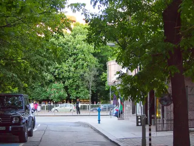 a car parked on a street next to a blue fire hydrant at Roza Home in Sofia