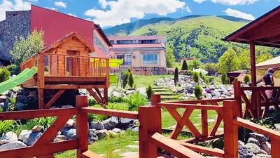 a backyard with a house and a playground at Тихият кът in Sapareva Banya