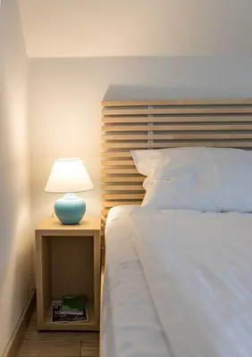a bedroom with a bed with a lamp on a night stand at Park Loft next to Eagle's Bridge in Sofia
