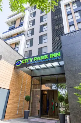 a city park inn sign in front of a building at City Park Inn in Plovdiv