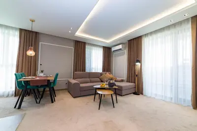 a living room with a couch and a table at City Park Inn in Plovdiv