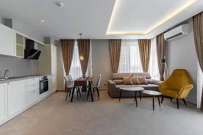 a living room with a couch and a table and chairs at City Park Inn in Plovdiv