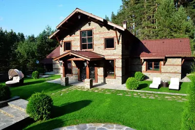 a house with a green yard with a building at Moiata Kashta Villa in Popovi Livadi