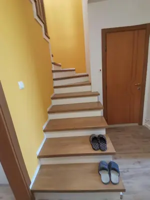a set of stairs with two pairs of slippers at Къща за гости 