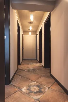 an empty corridor of an office building with a tile floor at Semiramis` Suite 2-bedroom Lux Apartment in Sofia