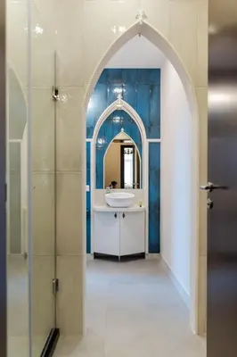 an archway in a bathroom with a sink and a mirror at Semiramis` Suite 2-bedroom Lux Apartment in Sofia