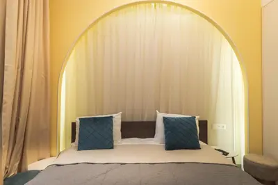 a bedroom with a large bed with blue pillows at Semiramis` Suite 2-bedroom Lux Apartment in Sofia