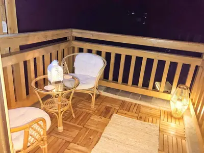 a balcony with a table and chairs and a table and chairs at Mirabell Apartment Bansko - Mountain View & Fireplace in Bansko