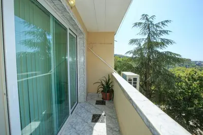 a balcony with a view of a tree at Мария Парк in Sandanski