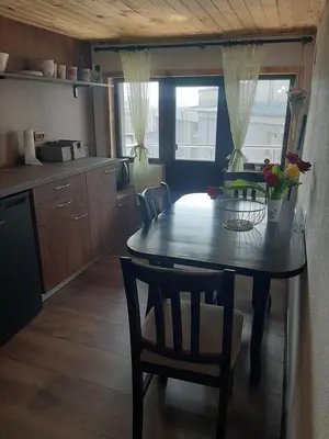 a kitchen with a table and chairs in a room at Къща за гости Алекс in Karlovo