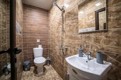 a bathroom with a sink and a toilet at Къща за гости Алекс in Karlovo