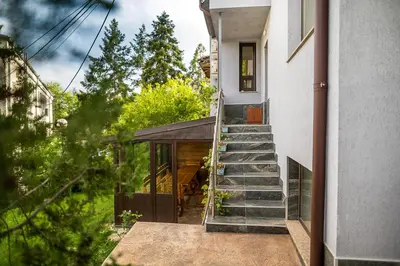 a house with a staircase leading up to a house at Къща за гости Алекс in Karlovo
