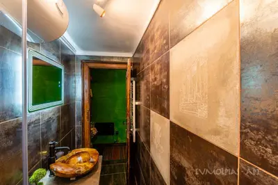 a bathroom with a sink and a wall at Art apartment EVMOLPIAS near Roman stadium in Plovdiv