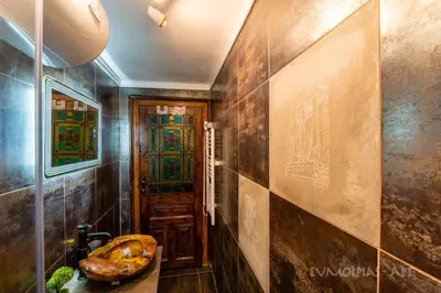 a bathroom with a sink and a stained glass door at Art apartment EVMOLPIAS near Roman stadium in Plovdiv