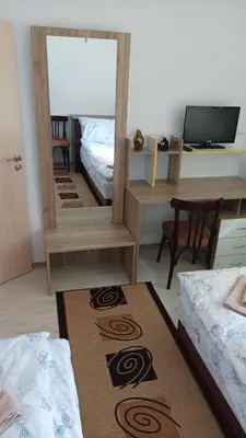 a room with a mirror and a bed and a table at Къща за гости - Софи, гр. Девин in Devin