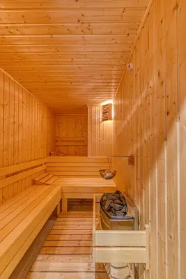 a wooden sauna with a tub in the middle at Pirin Style Villa & Spa in Bansko