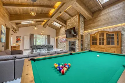 a large living room with a pool table at Pirin Style Villa & Spa in Bansko
