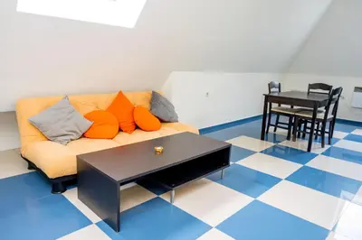 a living room with a couch and a table at Villa Kalina Apartments in Bansko