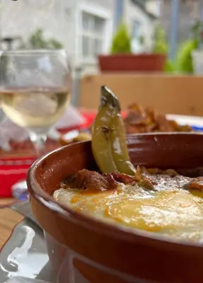 a bowl of food and a glass of wine at Къща за гости 