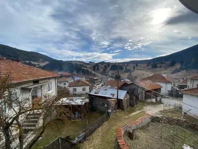 a view of a village with houses and mountains at Къща за гости 