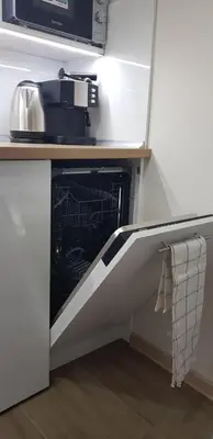 a dishwasher in a kitchen with a microwave at Landmark Apartment in Sofia