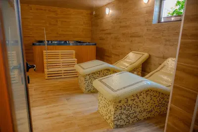a room with four chairs and a table and a heater at Вила Влахов in Sapareva Banya