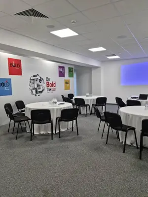 a conference room with white tables and black chairs at The Five Elements Hotel and SPA in Sapareva Banya