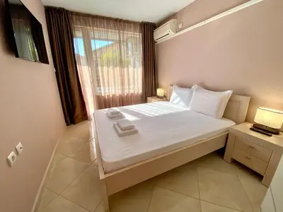 a small bedroom with a bed and a window at Irina Apartment in Sandanski