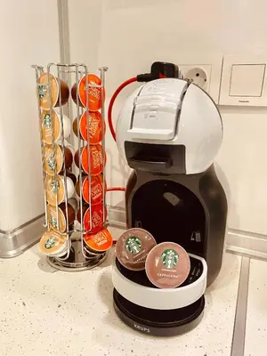 a coffee maker sitting on a counter next to a cup at Irina Apartment in Sandanski