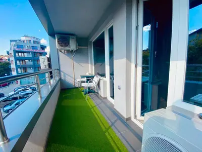 a balcony with green grass on the side of a building at Irina Apartment in Sandanski
