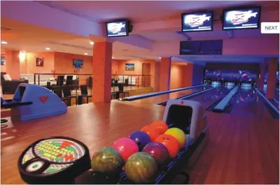 a bowling alley with pins and balls on the lanes at Grand Monastery Private Apartment in Pamporovo