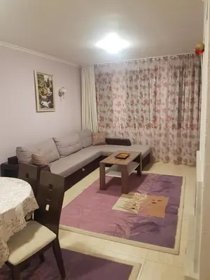 a living room with a couch and a table at Grand Monastery Private Apartment in Pamporovo