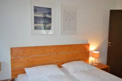 a bed with a wooden headboard in a bedroom at Cozy studio in 