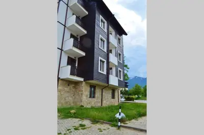 a black building with a fire hydrant in front of it at Cozy studio in 